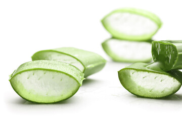 Pieces of aloe vera leaf on white background with shadow. Angle view. Selective focus.