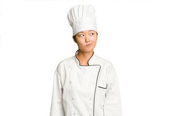 Young asian cook woman isolated confused, feels doubtful and unsure.