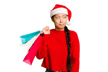 Young asian woman shopping a christmas presents isolated Young asian woman shopping a christmas...