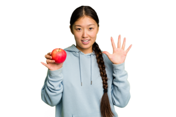 Young asian woman holding a red apple isolated smiling cheerful showing number five with fingers.