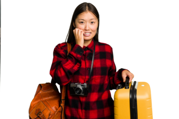 Traveler asian woman holding a suitcase isolated biting fingernails, nervous and very anxious.