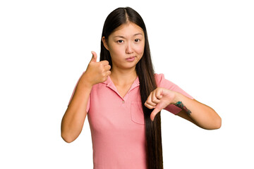 Young Asian woman isolated showing thumbs up and thumbs down, difficult choose concept