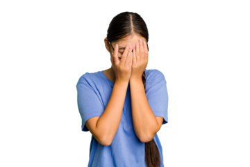 Young Asian woman isolated blink at the camera through fingers, embarrassed covering face.