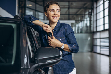 Woman holding car keys from a new car