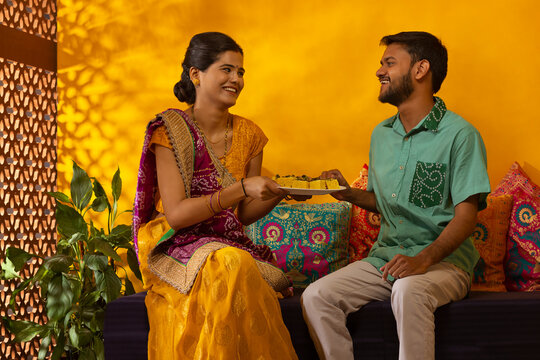 Gujrati woman offering dhokla to her husband