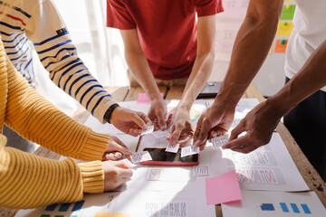 A UX design team is a confluence of user research, UX, UI design with layout paper on desk.