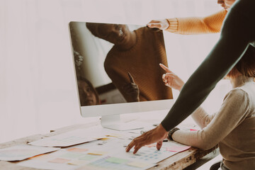 A UX design team is a confluence of user research, UX, UI design with layout paper on desk.