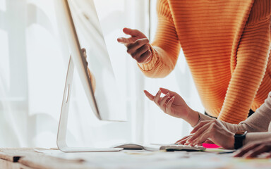 A UX design team is a confluence of user research, UX, UI design with layout paper on desk.