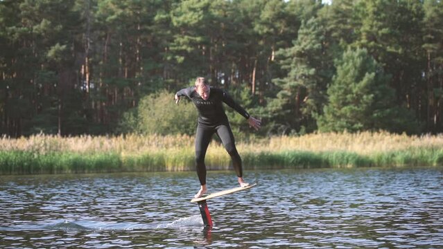 surfer on pump foil is foiling