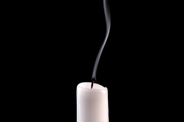 Extinguished candle with smoke isolated on black background