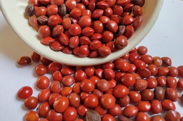 Red sandalwood or Red Lucky seeds or Ratangunja or  Adenanthera pavonina L.  Used as beads, in percussion instruments, also due to medicinal properties used as a medicine in Ayurveda, India.