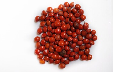 Red sandalwood or Red Lucky seeds or Ratangunja or  Adenanthera pavonina L.  Used as beads, in percussion instruments, also due to medicinal properties used as a medicine in Ayurveda, India.