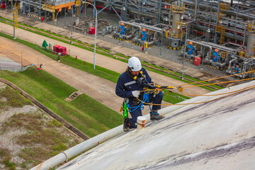 Male sit-down worker inspection wearing safety first harness rope safety line working at a high