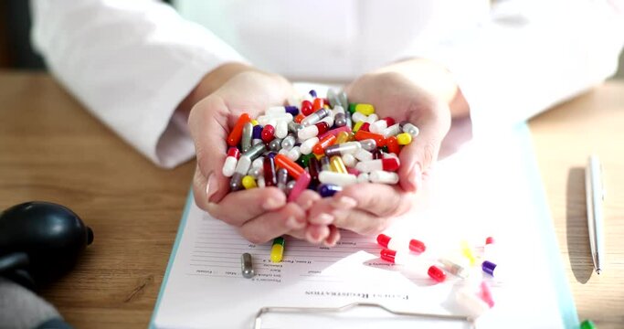 Doctor holding lot of multicolored pills in his hands closeup 4k movie slow motion 