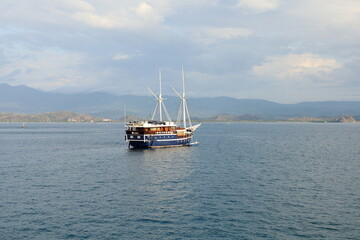 インドネシア、フローレス島の夕暮れの海に浮かぶ観光船。