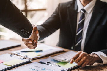 Business people shaking hands, finishing up a meeting.