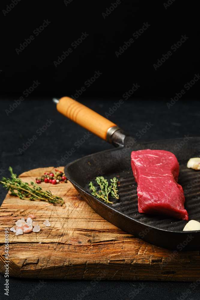 Wall mural Raw boneless beef tri-tip steak on frying pan