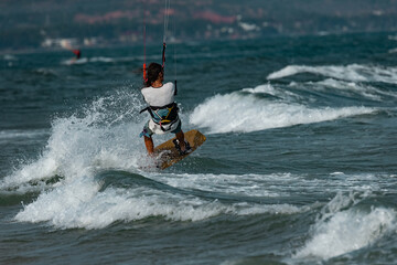 Kitesurfing on the waves of the sea in Mui Ne beach, Phan Thiet, Binh Thuan, Vietnam. Kitesurfing, Kiteboarding action photos Kitesurfer In action