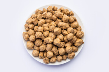 Glycine max or Soya bean or uncooked soybean chunks. Served in a bowl or as a Pile. selective focus