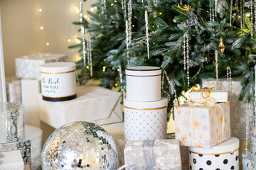 Christmas presents under the Christmas tree. New Year's and Christmas. Wrapped Gift. Beautiful packaging. Ribbon and bow on the packaging.