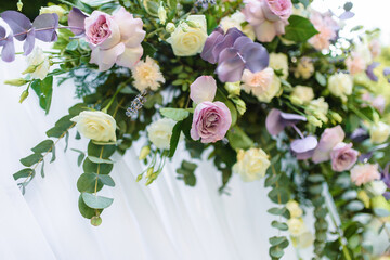 Obraz na płótnie Canvas White roses close-up in the wedding arch. Away wedding ceremony. High quality photo