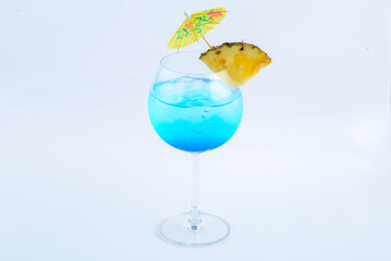 Blue hawaii soda with pineapple. Beverage for summer with white background.