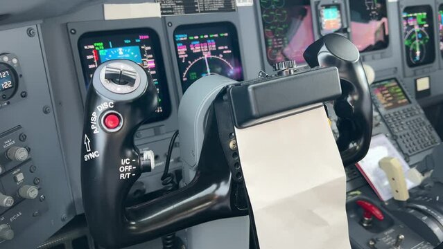 Close view inside a jet cockpit of the captain control wheel in a moder cristal cockpit. 4k