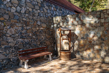 Bench and well near the stone wall