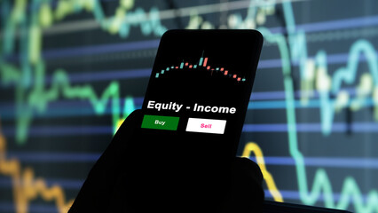 An investor's analyzing the Equity - Income etf fund on screen. A phone shows the ETF's prices...