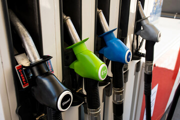 Various gasoline petrol pumps on a gas station. Fuel nozzles oil dispensers. Petrol gas diesel fuel prices concept