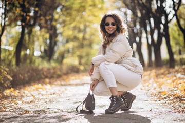 Portrait of beautiful woman smiling and walking in park