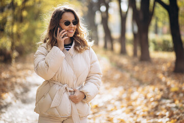Portrait of beautiful woman smiling and talking on the phone