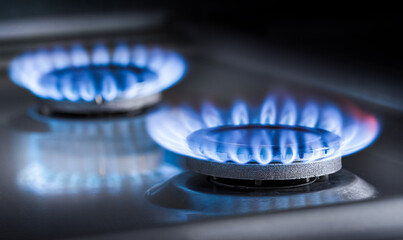 two burning gas burners on a kitchen gas stove - obrazy, fototapety, plakaty