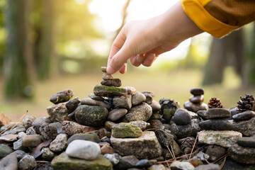  building a stone tower with one's hands at temple