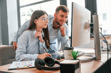 Two young designers is working together in the office