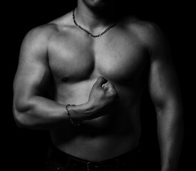Naklejka na ściany i meble Bodybuilder showing his muscular body isolated on black background