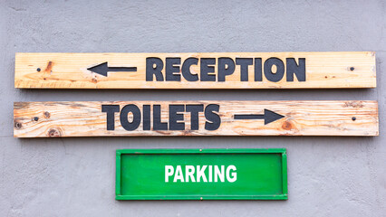 Signboards Words Reception Toilets Parking Wood Wall Outdoors