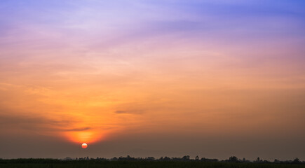 Sunset sky in the evening with colorful orange sunlight clouds on twilight, Dusk sky background 