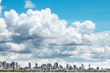 Obraz premium Clouds over city of João Pessoa in Brazil with many buildings
