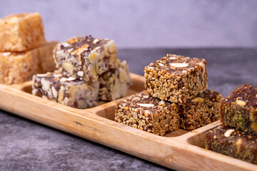 Mixed Turkish delight varieties on a dark background. Pistachio, hazelnut and fruit flavored Turkish delights. close up