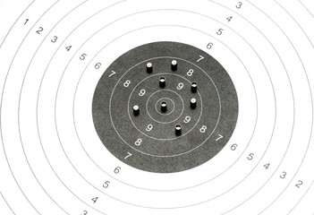 Simple black and white shooting target and metal pellets laying on top. Airguns, air gun ammunition...
