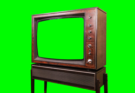 Old vintage TV with green screen isolated on green background. Side view.
