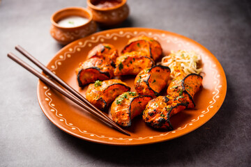 Tandoori momo, veg or non veg in red and cream sauce, served with sauce.  Nepal and Tibet recipe