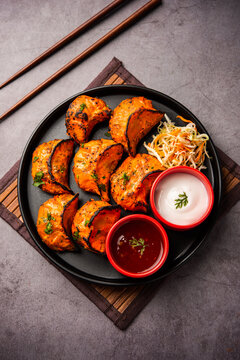 Tandoori momo, veg or non veg in red and cream sauce, served with sauce.  Nepal and Tibet recipe