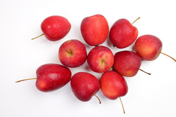 Small red Autumn Strawberry shaped Apple on white background