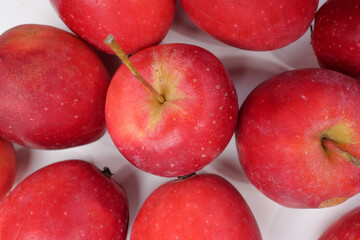 Fototapeta na wymiar Small red Autumn Strawberry shaped Apple on white background