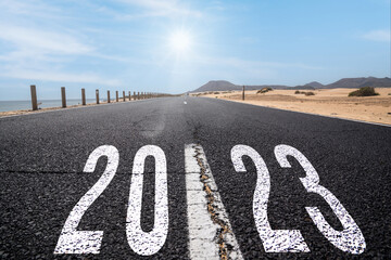 Start, 2023 New Year road trip travel and future vision concept . Nature landscape with highway road leading forward to happy new year