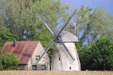 a windmill in the countryside in summer