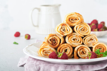 Pancakes. Stack of crepes or thin pancakes with berries, with raspberries and honey for breakfast. Pancake day is traditional american or english holiday concept. Homemade breakfast. Selective focus.
