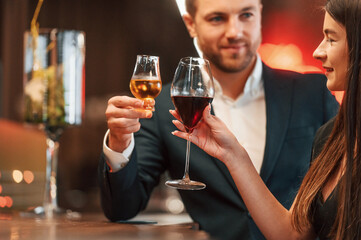 Sitting and drinking. Man and woman is together in the bar